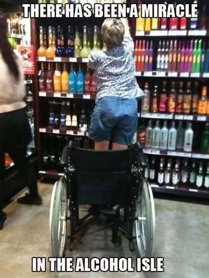 woman standing out of her wheelchair to reach for bottle of liquor, with the caption there has been a miracle in the alcohol isle